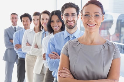 Smiling workers in a line looking at the camera