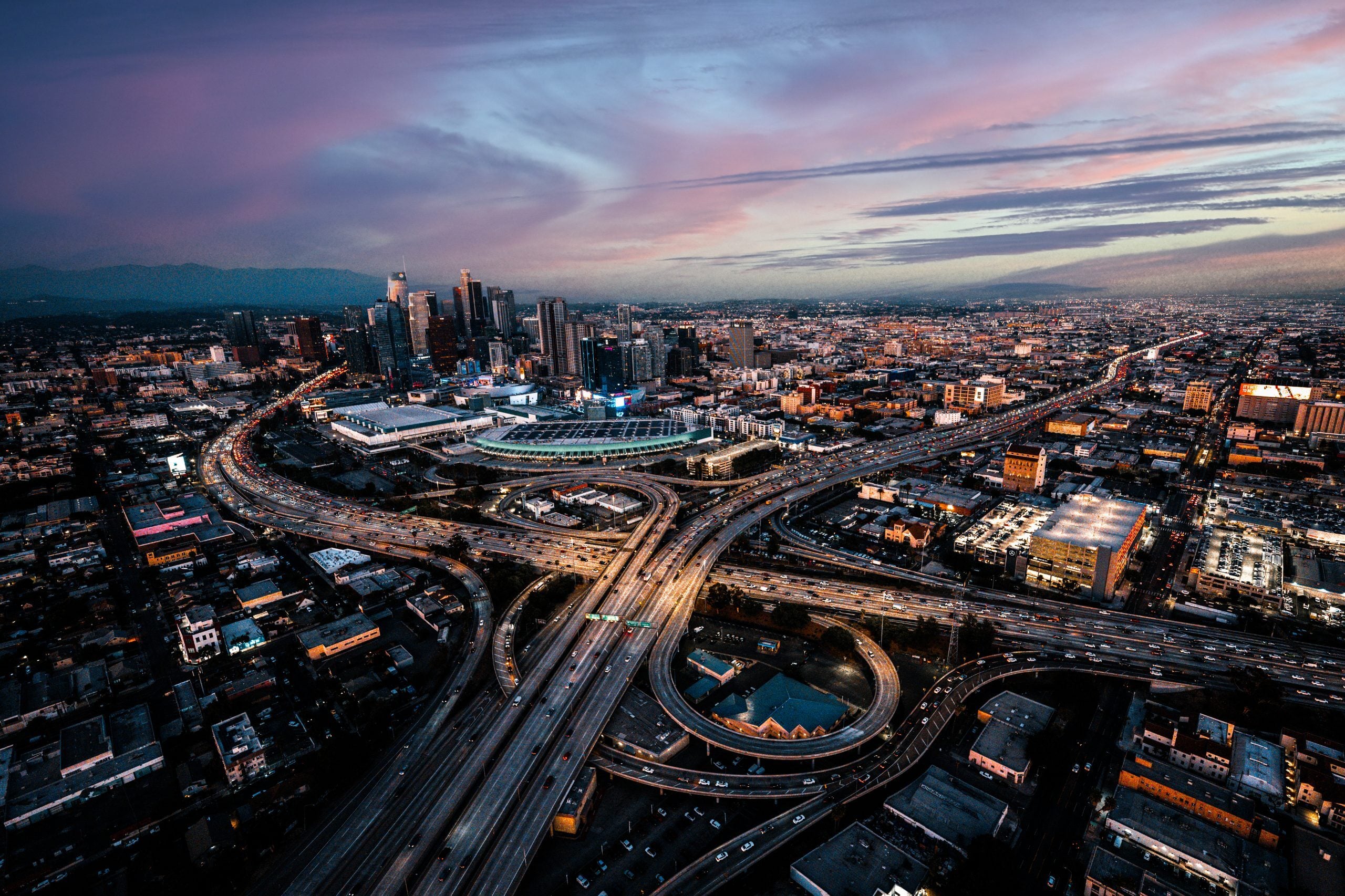 Aerial view of a city freeway interchange at dusk.